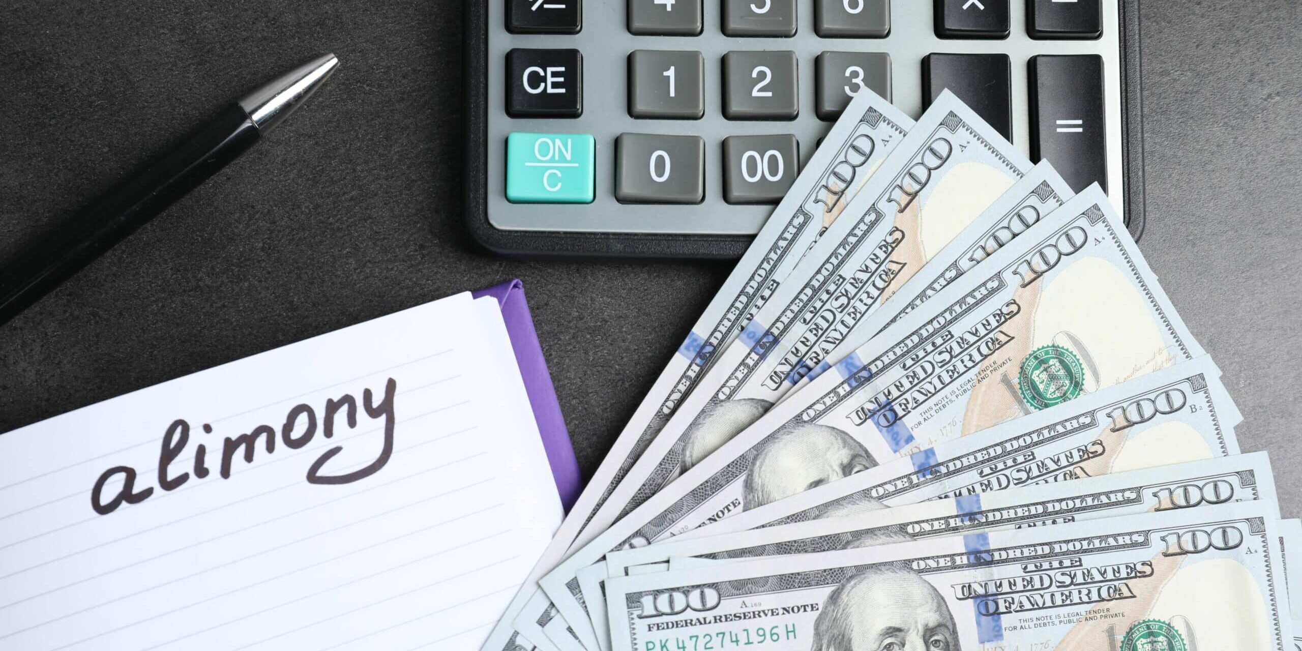 Notebook with word Alimony, dollar banknotes, calculator and pen on grey table, flat lay
